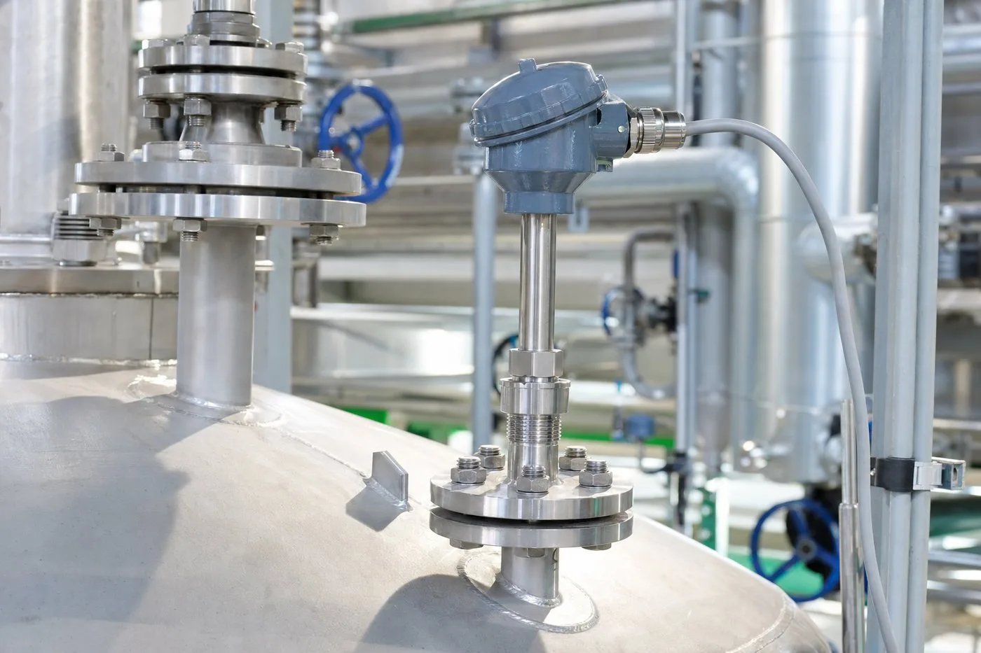 Connection-head temperature sensor and thermowell on chemical process vessel piping